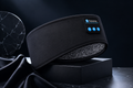 Black headband with digital display and buttons on a dark background